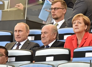 Vladimir Putin, Sepp Blatter and Angela Merkel at the 2014 World Cup opening ceremony.
