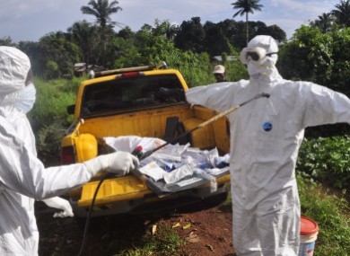 A health worker sprays disinfectant on the outskirts of Monrovia, Liberia.