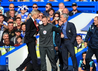 Chelsea manager Jose Mourinho (right) has a heated exchange with Arsenal manager Arsene Wenger (left) on the touchline.