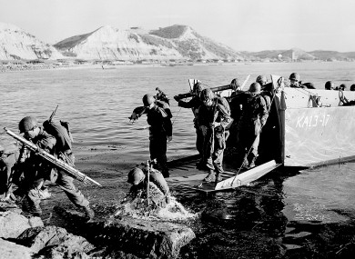 In this July 19, 1950 file photo, troops of the First U.S. Cavalry Division land ashore at Pohang on the east coast of Korea during the Korean War.