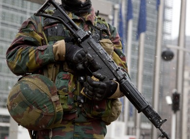 A Belgian soldier patrols in front of EU headquarters in Brussels today.
