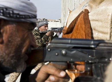 Fighters from the Free Syrian Army, left, and the Kurdish People's Protection Units (YPG), centre.