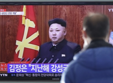A man watches a TV news program showing North Korean leader Kim Jong-Un's New Year speech.