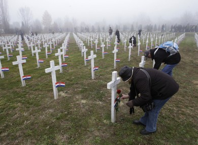 People lay flowers on crosses at Vukovar's memorial cemetery, on the 20th anniversary of the fall of Vukovar. The border city saw intense fighting in 1991.