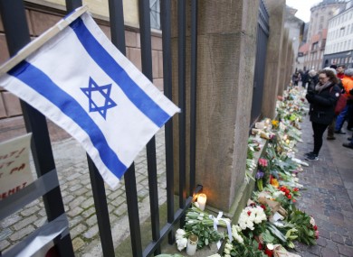 A Israeli flag is fixed to the fence of a synagogue where one person was killed in Copenhagen.