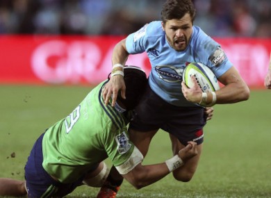 Manu tackles Adam Ashley-Cooper in a Super Rugby match.