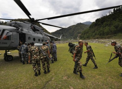 Nepal army soldiers get down from an Indian Air Force helicopter at higher reaches of mountains to help and evacuate earthquake victims.