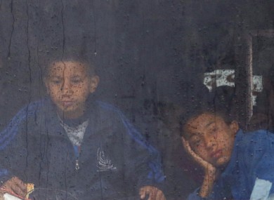 Kids travel home on a bus in Nepal.