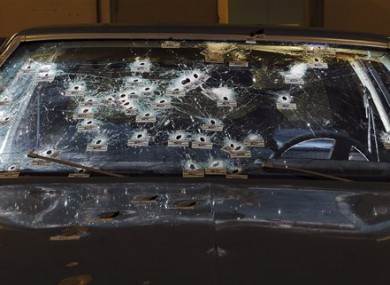 The bullet-ridden windshield of the car.