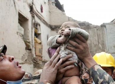A four-month-old baby boy is rescued from the rubble of his house in Bhaktapur, last Sunday.