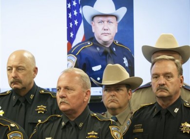 Law enforcement officers stand together after the fatal shooting.