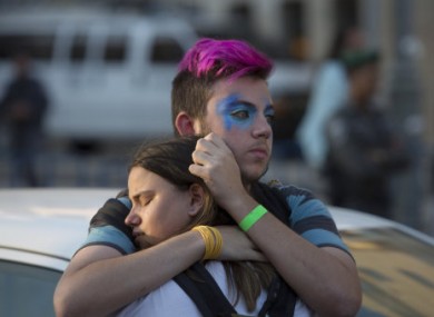 Onlookers react after an ultra-Orthodox Jew attacked people during a Gay Pride parade in central Jerusalem