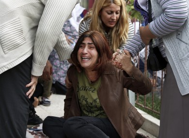 A relative of a person killed in Saturday's bombing attack reacts outside a hospital's morgue as they wait for the funeral in Ankara.