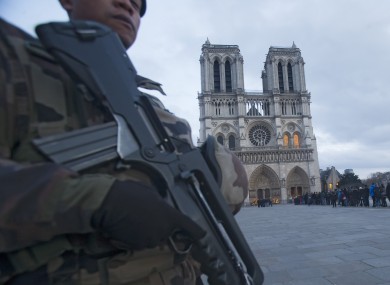 A soldier patrols in front of Notre Dame cathedral
