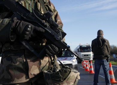 A French soldier and police officer monitor the border between France and Belgium.