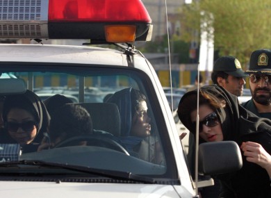 File photo from 2007: Women who were detained for not adhering to the strict Islamic dress code sit in a police vehicle in Tehran