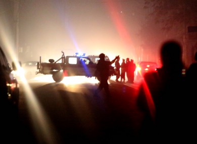 Afghan security forces inspect the site of the explosion where three were wounded.