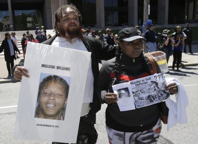 Alfredo Williams, left, and Renee Robinson, cousins of Malissa Williams who is one of the victims, protests outside the courthouse after the Michael Brelo verdict in May last year.