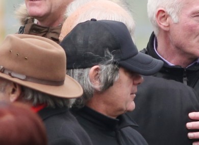 Hutch, pictured wearing a wig as a disguise at his brother's funeral on Friday.
