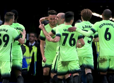 Manchester City players celebrate David Faupala's goal.