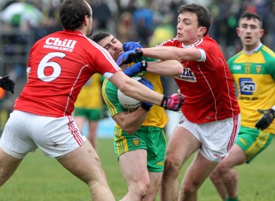 Donegal's Paddy McGrath tries to battle past the Cork duo of Mark Collins and Brian O'Driscoll.