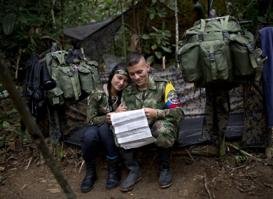 Farc rebel Juliana sits with her boyfriend, Alexis, in their makeshift tent.