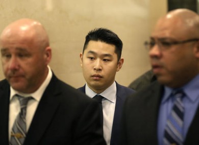 Peter Liang, centre, leaves the courtroom after his sentencing in New York.