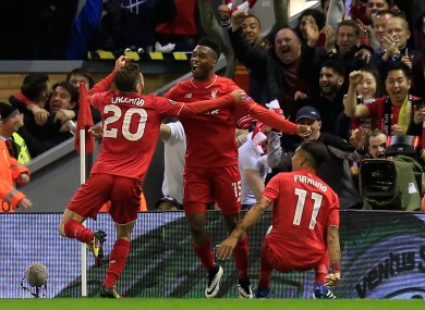 Goalscorers Daniel Sturridge and Adam Lallana celebrate with Roberto Firmino.