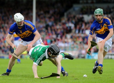 Tipperary duo Michael Cahill and Cathal Barrett with Limerick's Graeme Mulcahy in yesterday's clash in Thurles.