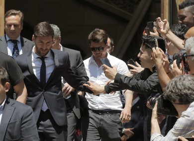 Barcelona soccer player Lionel Messi, left, leaves the court on Thursday.