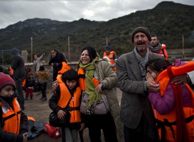 A family embraces after arriving on a vessel from the Turkish coast to the Greek island of Lesbos.