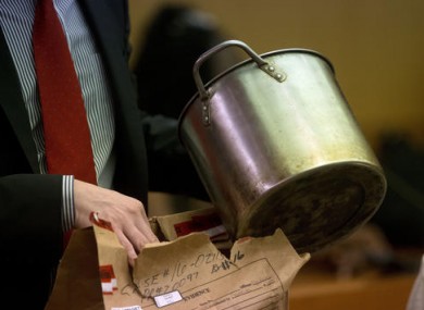 During the trial for Martin Blackwell a lawyer holds a pot they say Blackwell used to pour boiling water on his girlfriend's gay son and his friend as they slept.