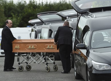Coffins are taken to hearses at the scene in Oakdene, Barconey, Ballyjamesduff in Cavan.