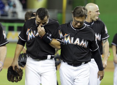 Martin Prado is consoled by Miami Marlins team manager Don Mattingly.