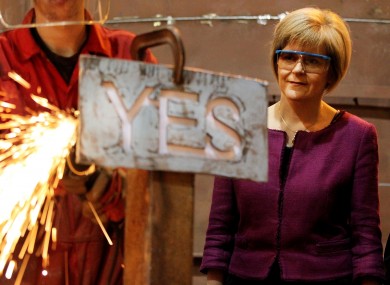 Nicola Sturgeon watching an apprentice manufacturing a steel 'Yes' sign in September 2014.