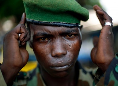 A Seleka Presidential Guardsman adjusts his beret at the downtown market in Bangui, Central African Republic.