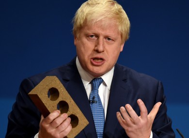 Boris Johnson holds a brick during a 2014 speech