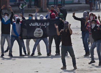Muslim protesters hold a flag of Islamic State as they shout anti-India slogans during a protest in Srinagar, Indian controlled Kashmir.