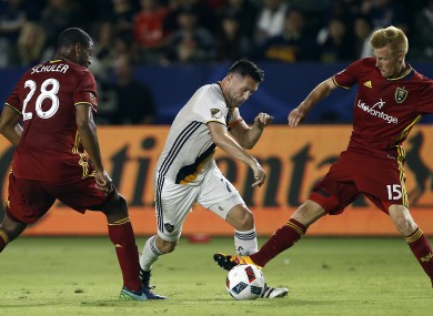 Keane tries to split Chris Schuler, left, and Justen Glad during last night's Western Conference playoff match.