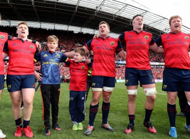 Tony and Dan Foley sing with the Munster players after the game.