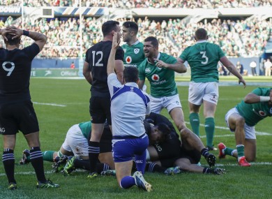 Ireland's Rob Kearney, centre, signals as his team scores against New Zealand.