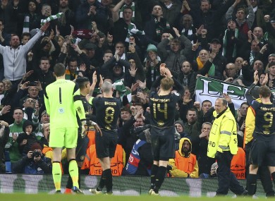 Celtic players celebrate with fans last night.