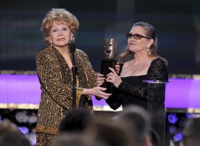 Carrie Fisher, right, presents her mother Debbie Reynolds with the Screen Actors Guild life achievement award at the 21st annual Screen Actors Guild Awards at the Shrine Auditorium in Los Angeles last year.
