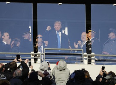 Trump acknowledges spectators during the first half of the Army-Navy NCAA college football game in Baltimore yesterday.