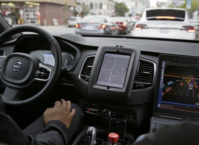 An Uber driverless car waiting in traffic