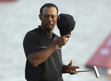 Tiger Woods walks off the 18th green during the first round at the Hero World Challenge golf tournament.