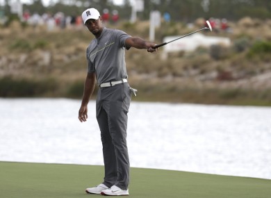 Tiger Woods reacts after hitting on the 16th hole during the third round at the Hero World Challenge golf tournament.
