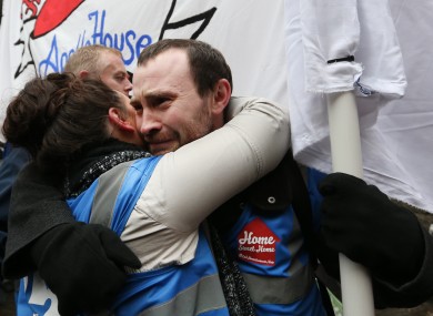 Activists hug each other this morning outside Apollo House.