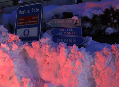 A sign for the Hotel Rigopiano, almost completely covered in snow following the avalanche