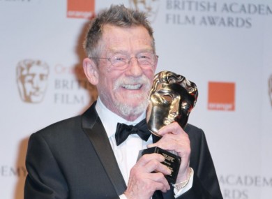 John Hurt poses with the award for 'Outstanding Contribution to Cinema' backstage at the Bafta Film Awards, 2012